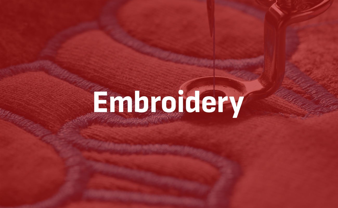 Embroidery teaser with a machine embroidering some stitching Embroidery teaser with a machine embroidering some stitching